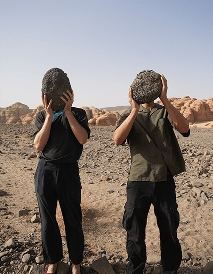 Two people displaying stones